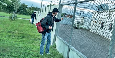 A critical infrastructure’s site security plan needs to address all three areas of risk: traditional physical security, process security and safety security. Man standing at a fence